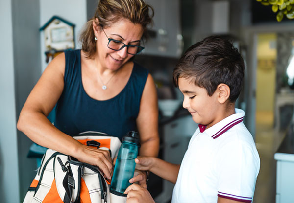 Mother helping her son get ready for school